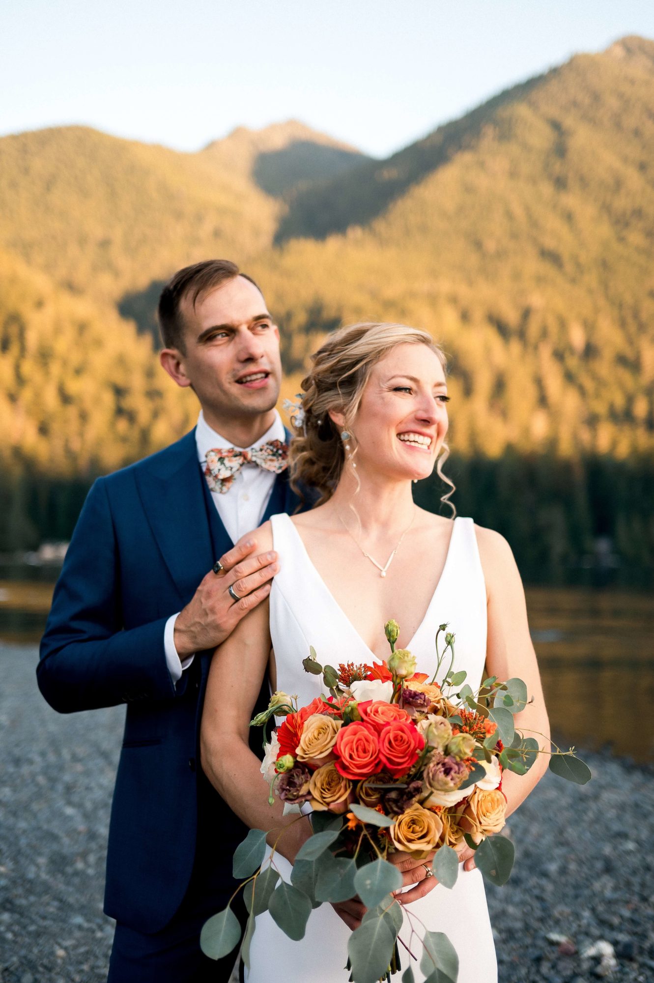 Bride and groom together in front of mountains