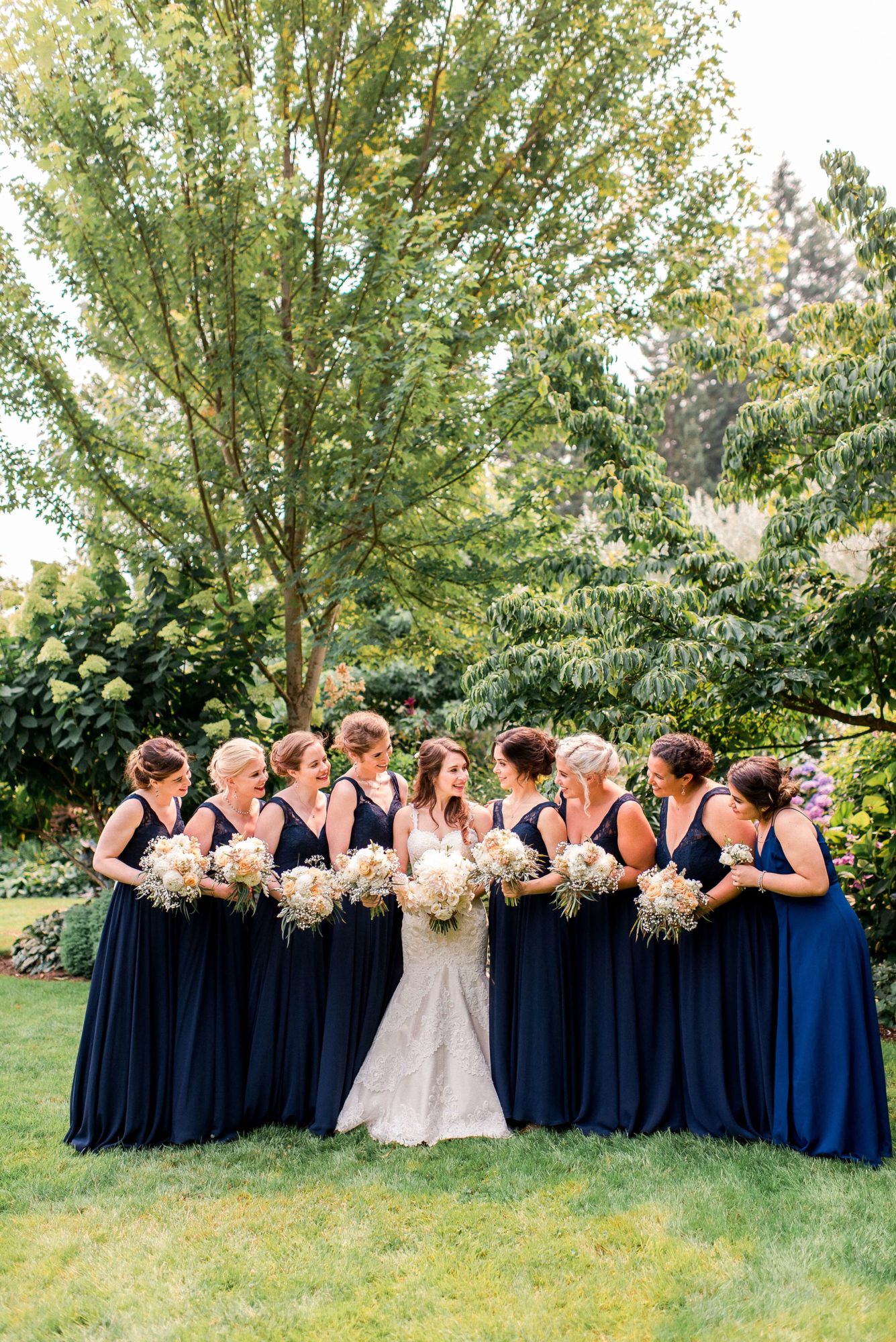 Fireseed catering wedding bridal party holding flower bouquets while in the garden