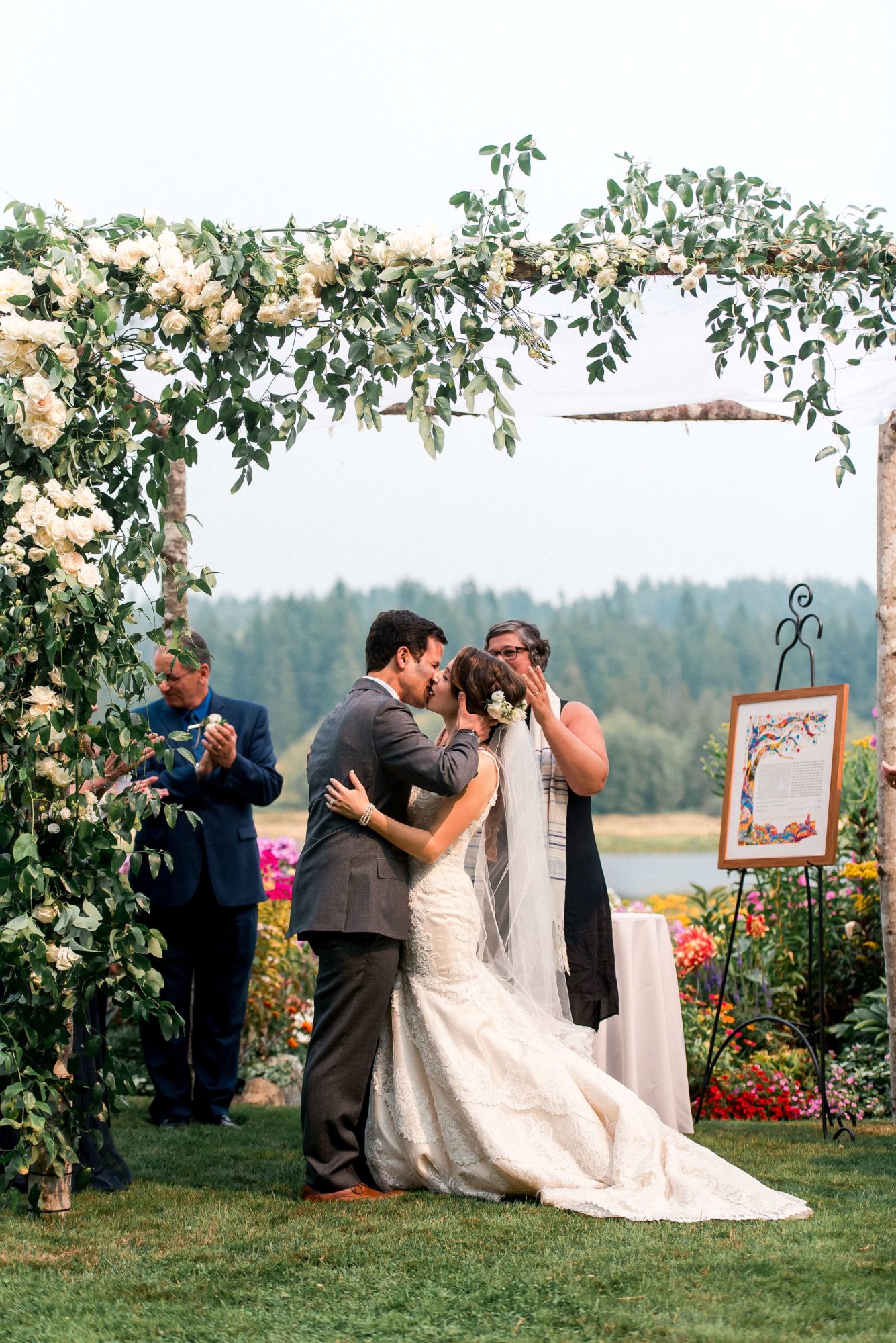 bride and groom first kiss at outdoor Fireseed catering wedding