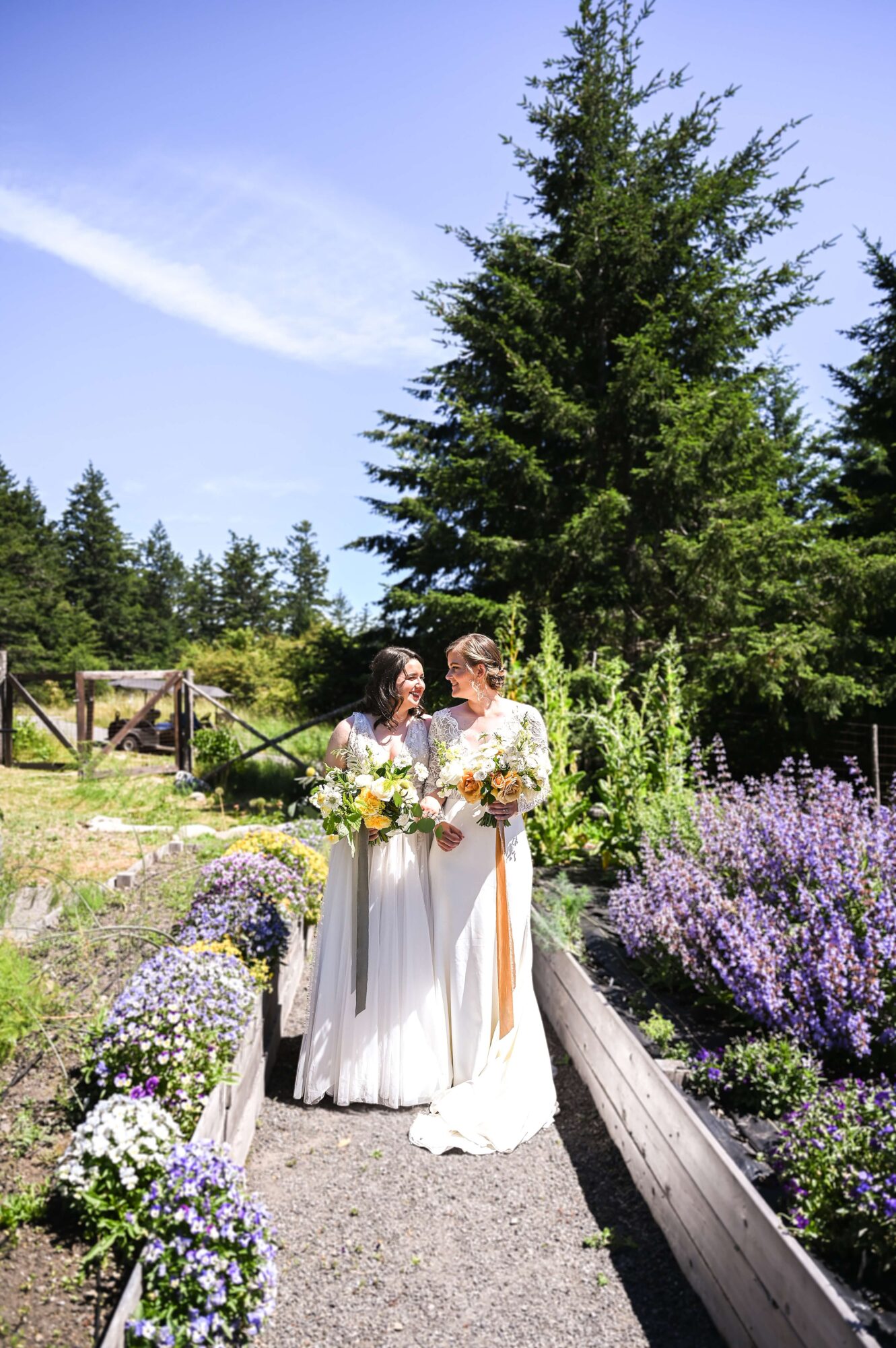 Two brides in the garden at their LGTBQ+ wedding at Saltwater farm on San Juan Island