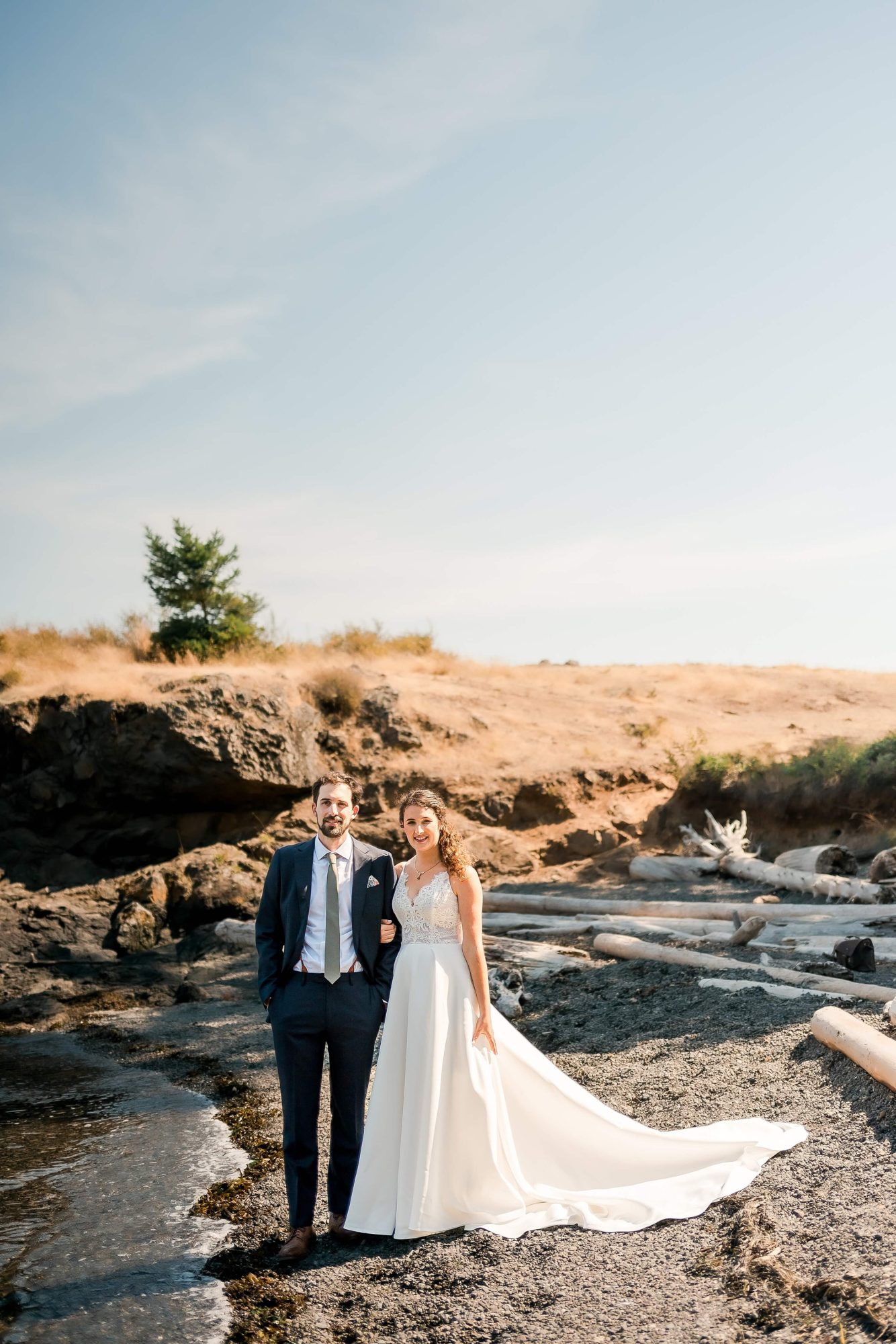 bride and groom standing near the edge of the water at their San Juan Island Wedding