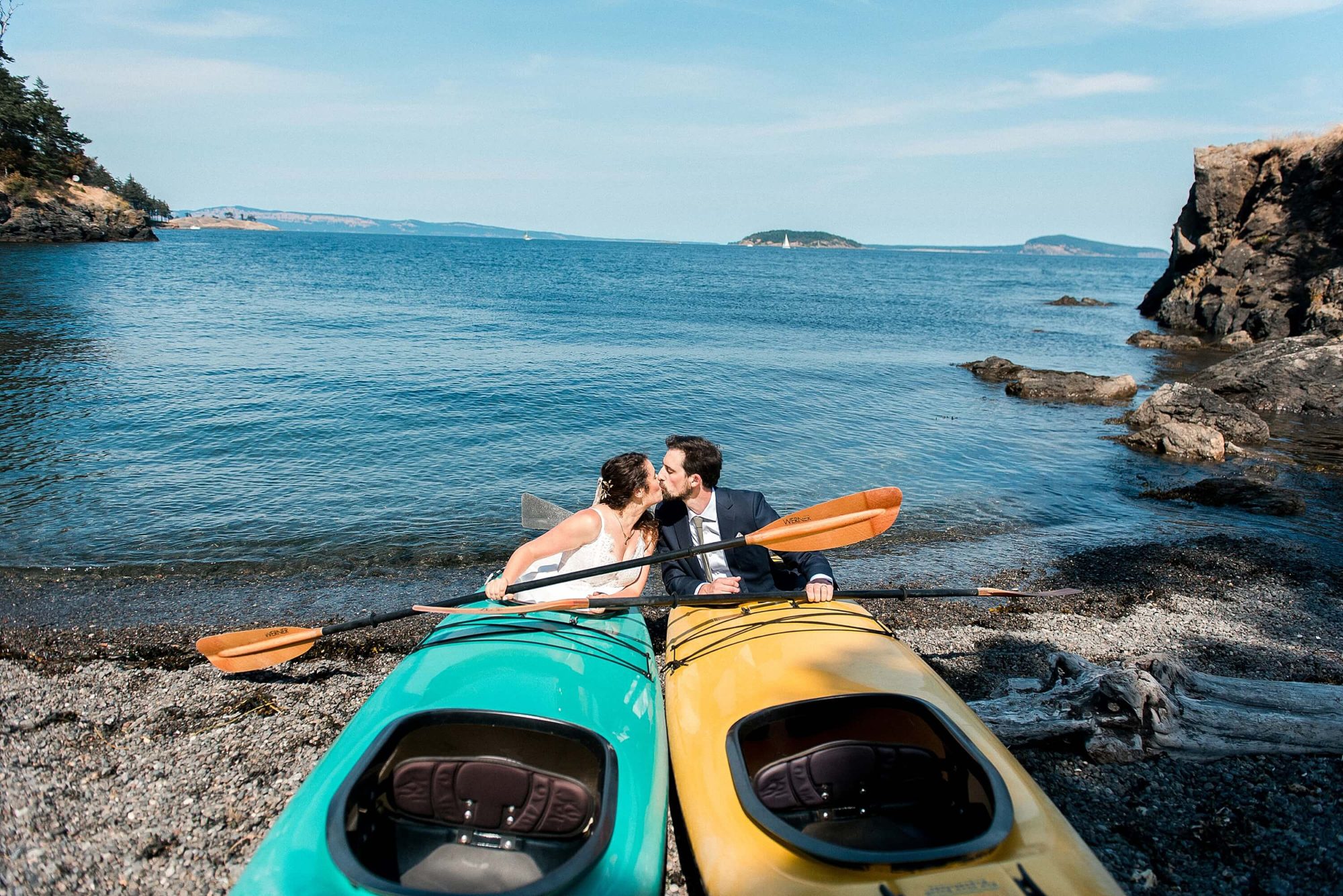 bride and groom kissing in a kayak during their at their San Juan Island Wedding