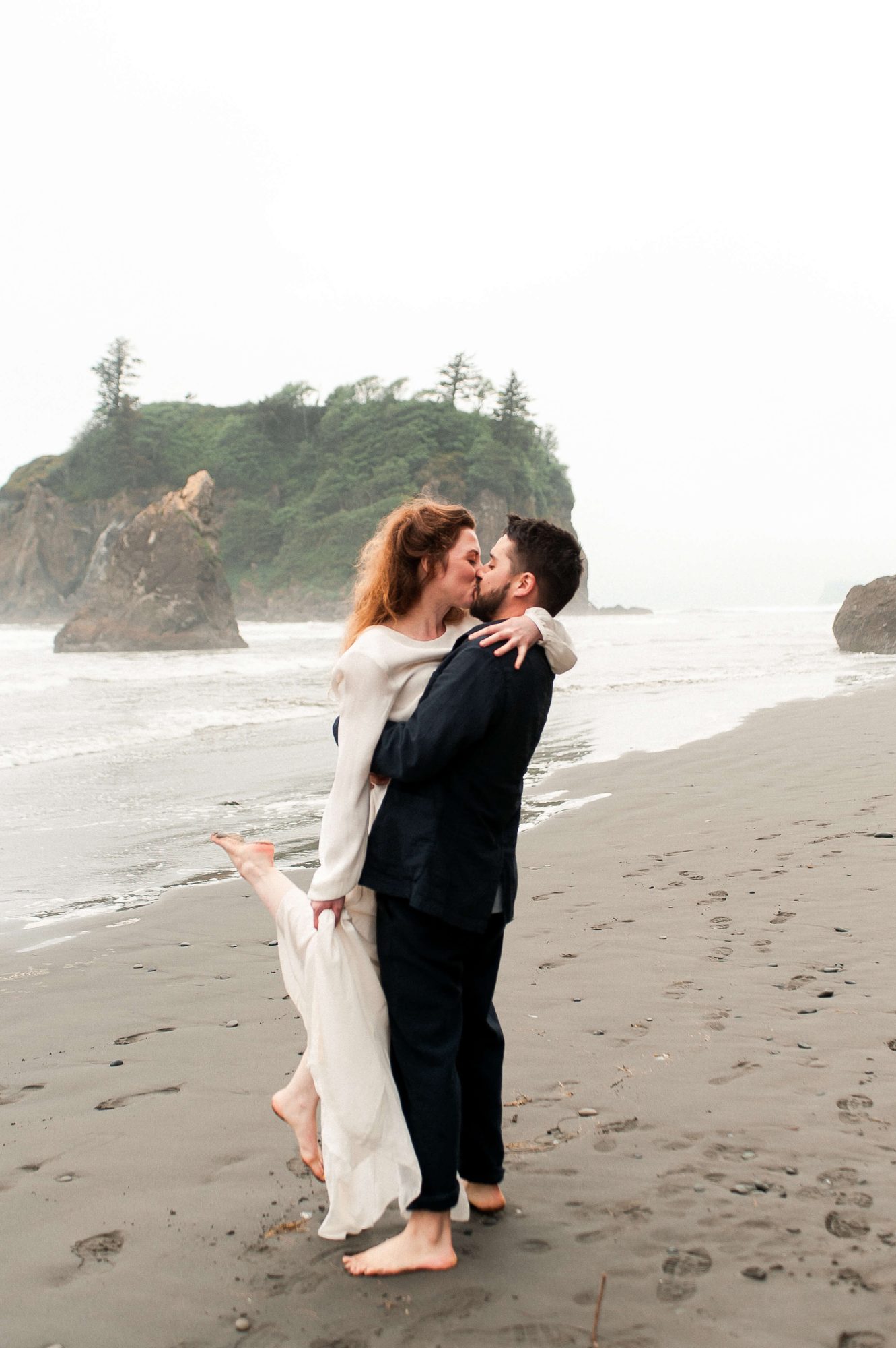 bride and groom kissing on the beach at their Seabrook wedding