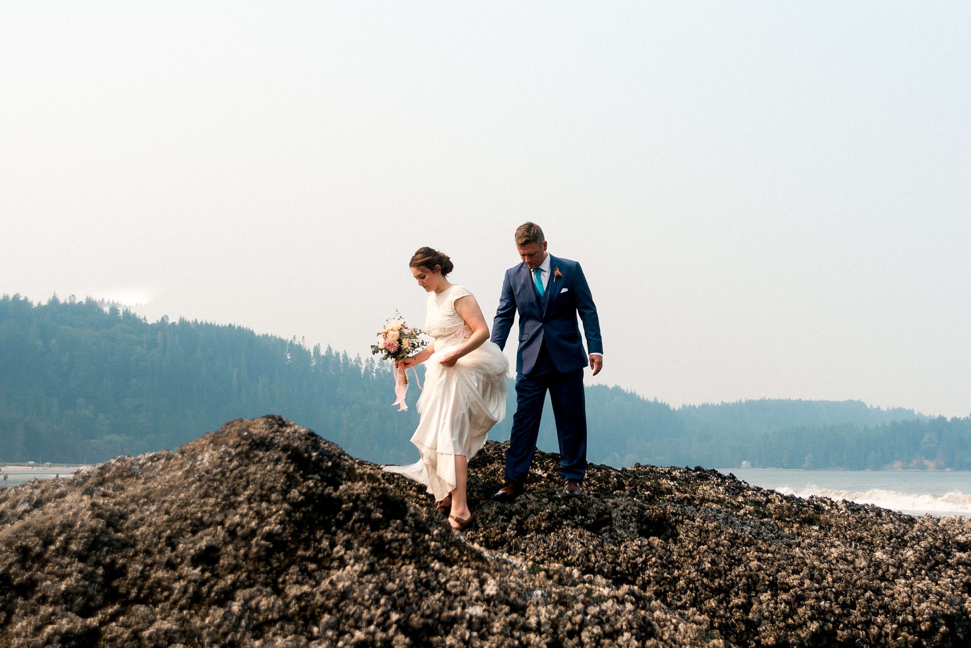 bride and groom adventuring through rocks at their Seabrook wedding