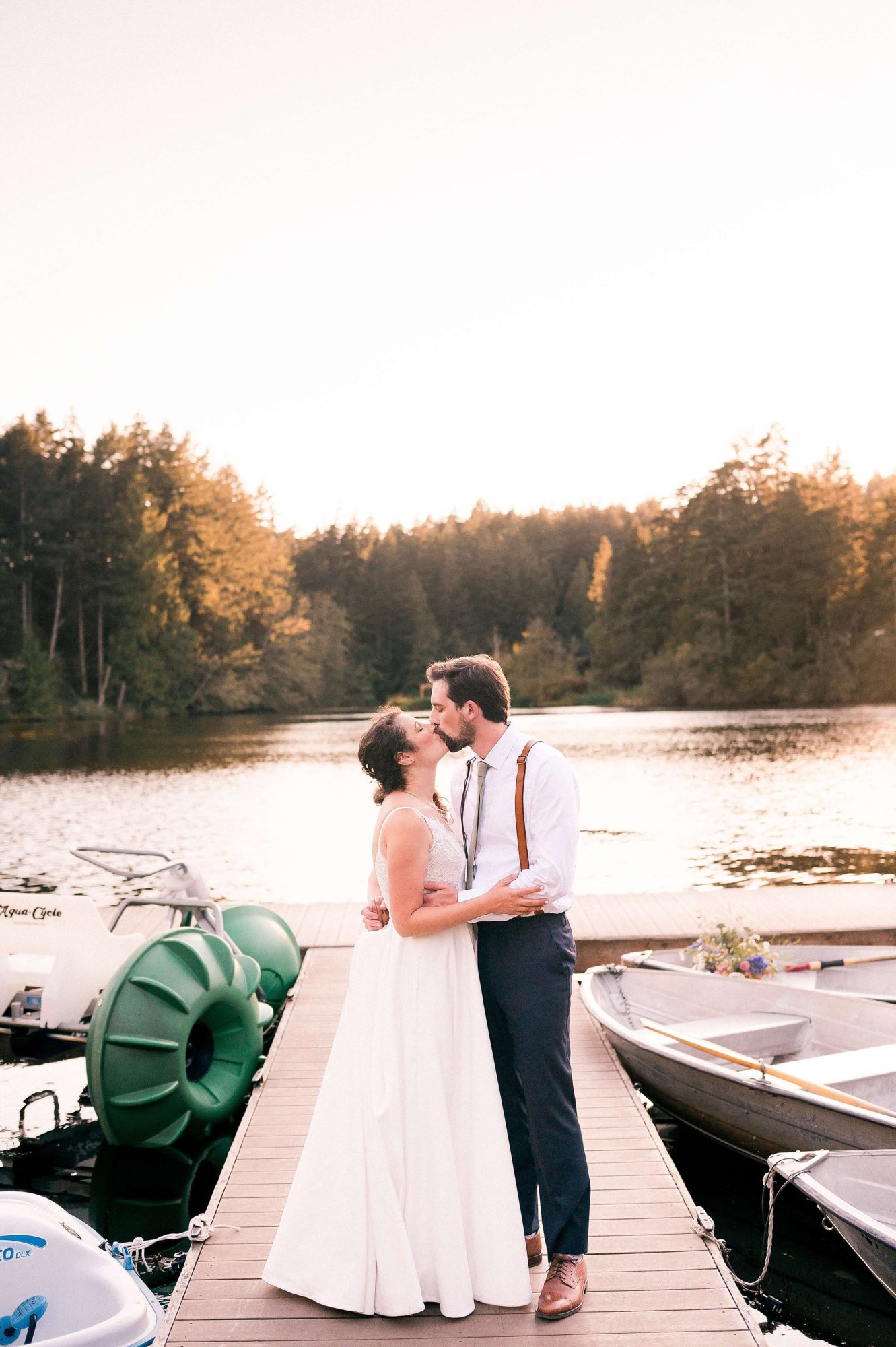 bride and groom kissing on a dock at their Lakedale Resort Wedding