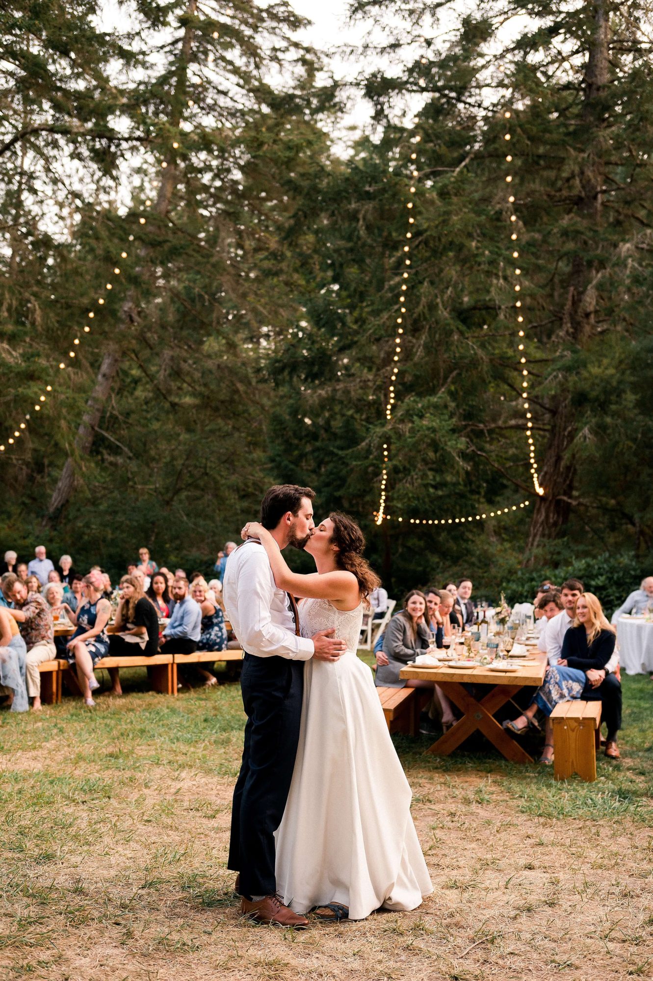 Bride and groom kissing under market lights at their Lakedale Resort Wedding