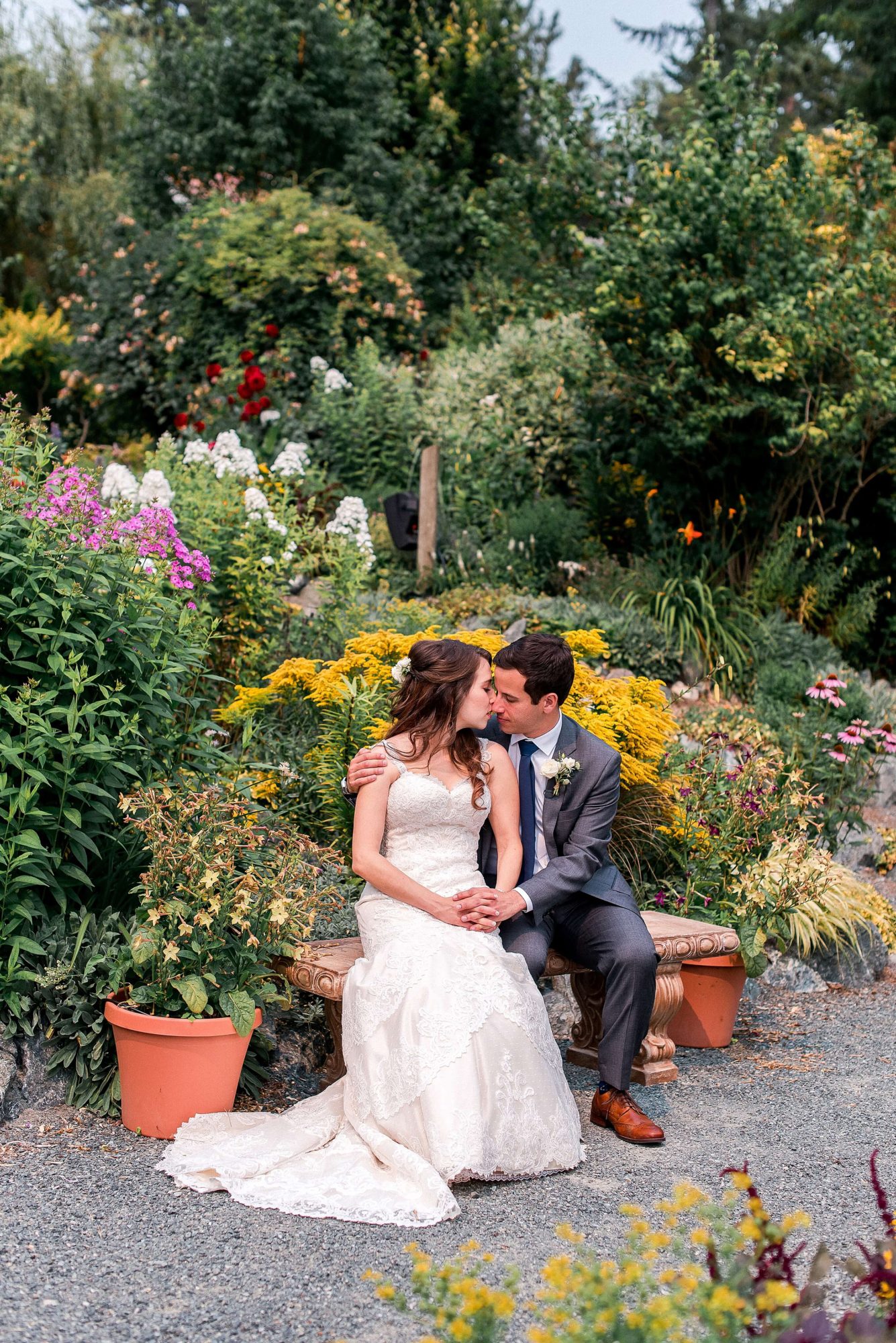 bride and groom nuzzling in a garden at their Whidbey Island Wedding