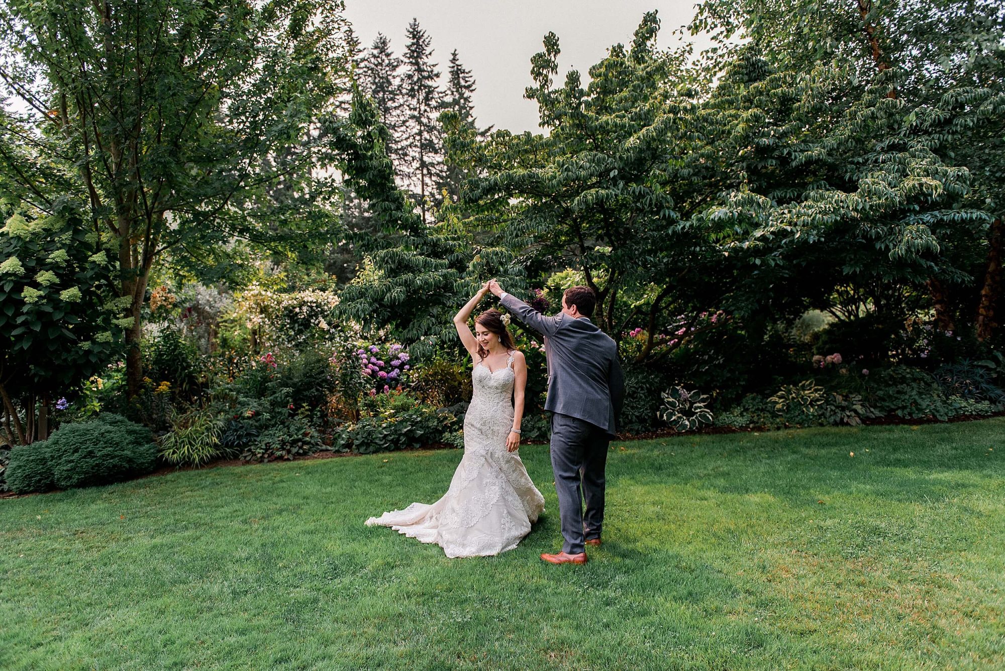 bride and groom dancing on a lawn at their Whidbey Island Wedding