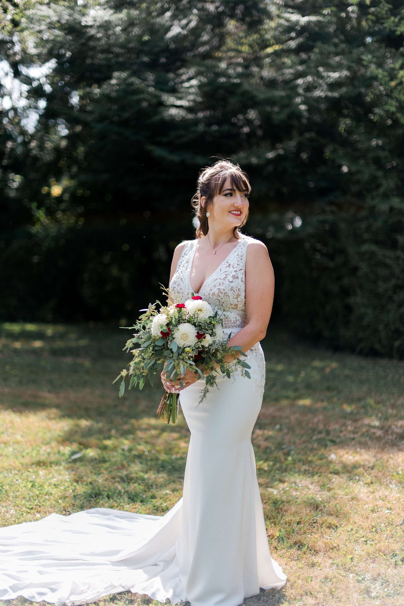 bride holding a bouquet and looking off into the distance at their Whidbey Island Wedding