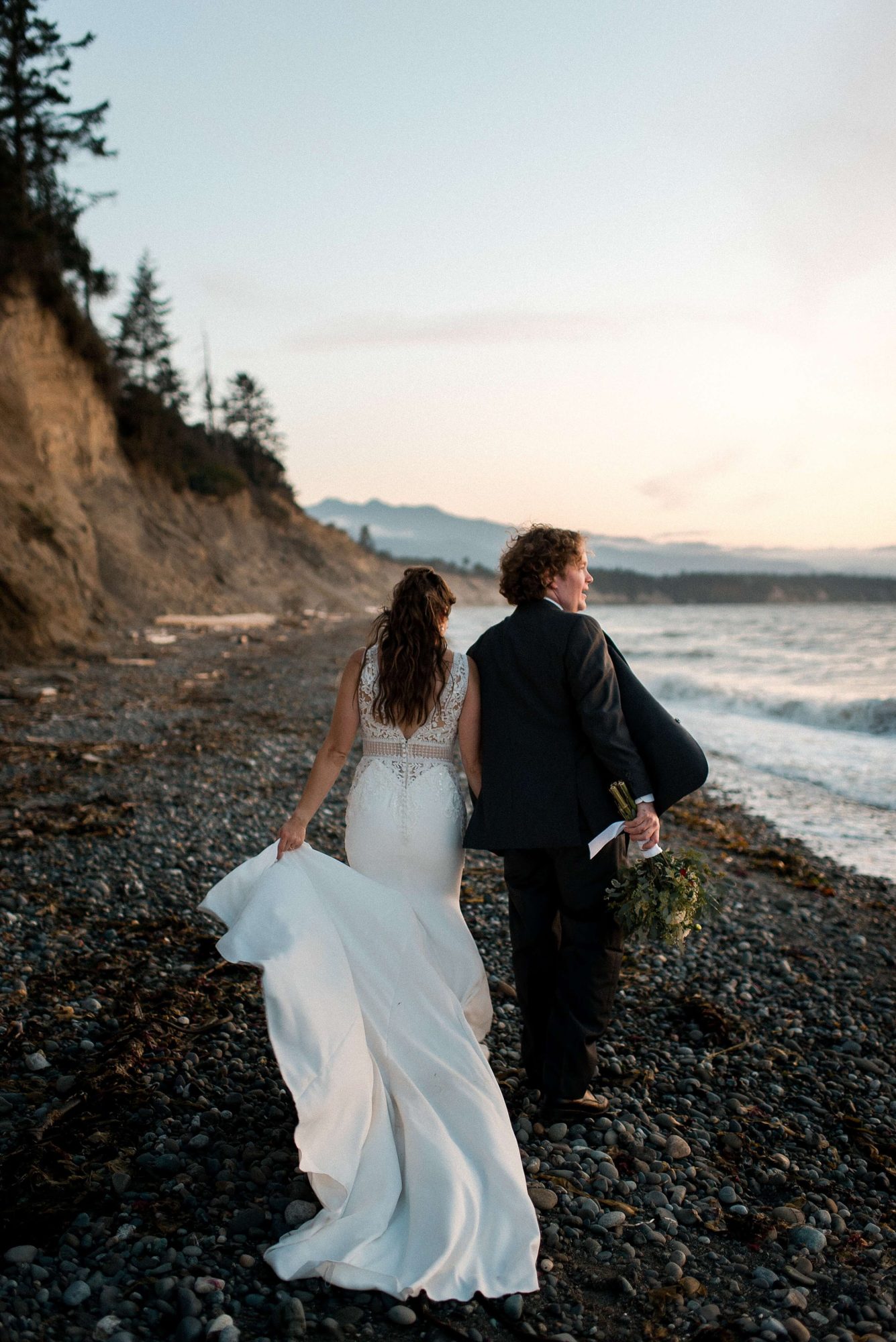 bride and groom walking along the beach at their Whidbey Island Wedding