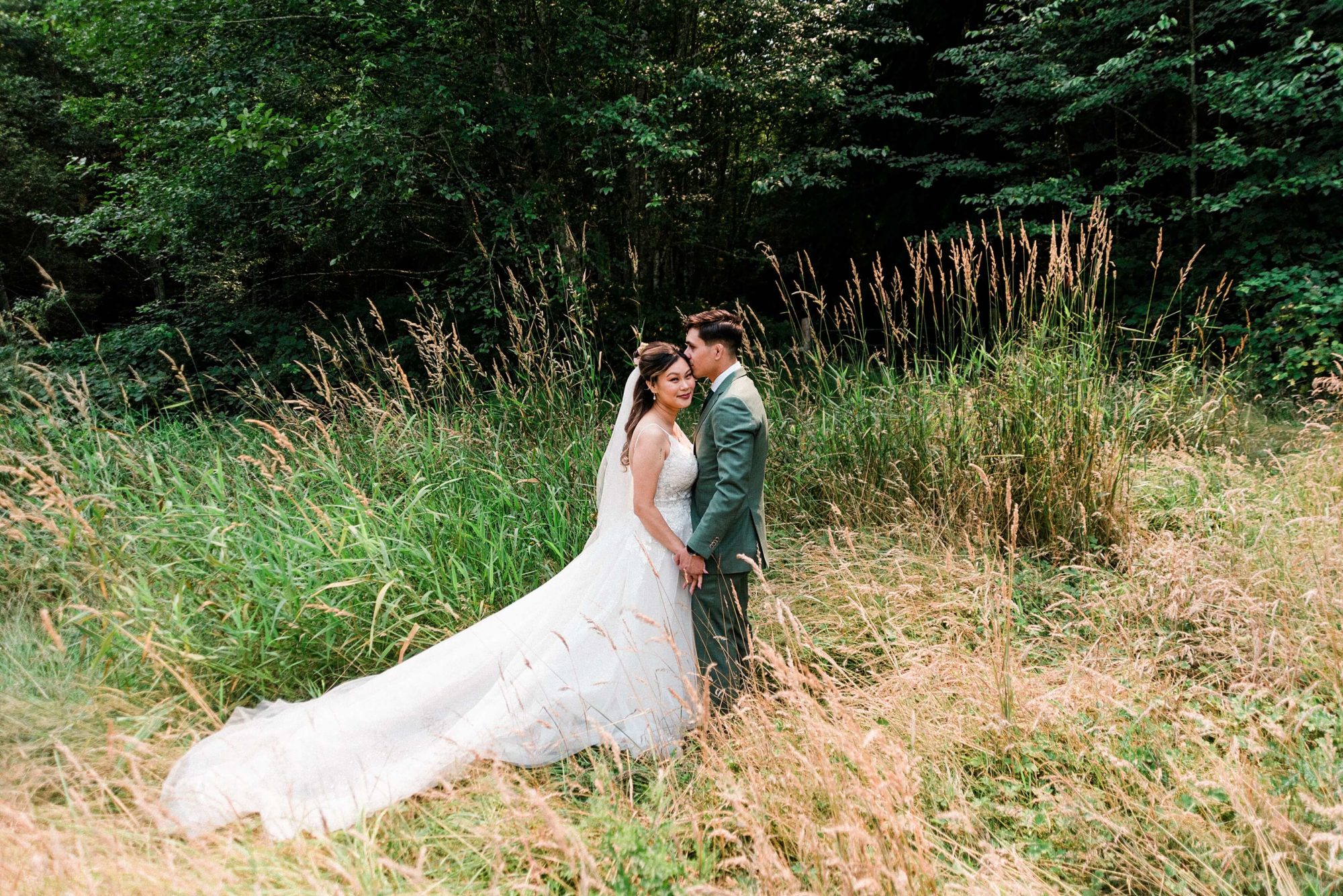 Bride and groom in a meadow at Misty Clover Farm Olympic Peninsula Wedding Venue