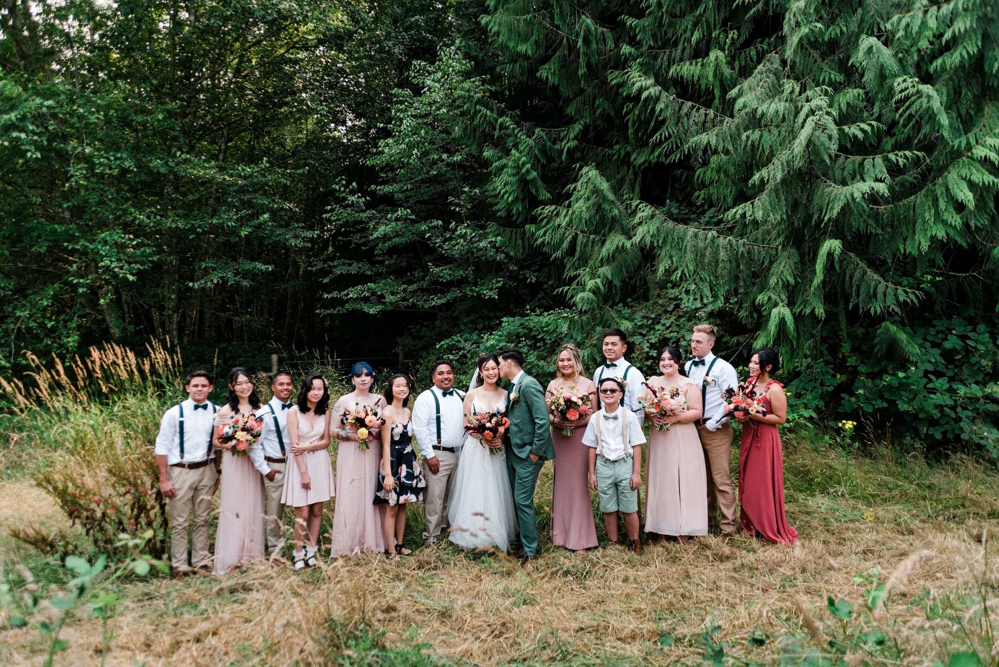 Bride, groom, and bridal party in a meadow at Misty Clover Farm Olympic Peninsula Wedding Venue