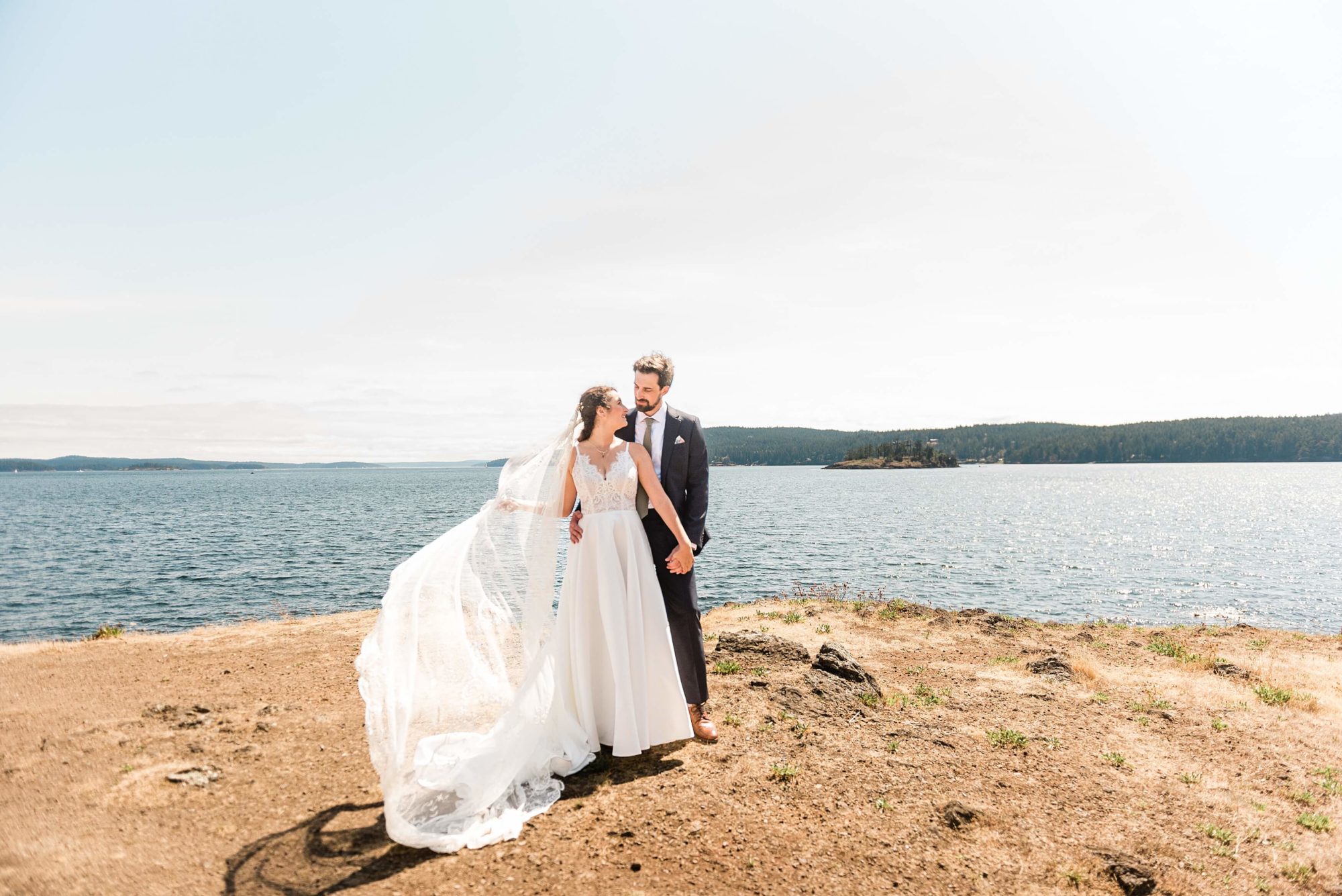 Bride and groom on a rocky beach in the San Juan Islands