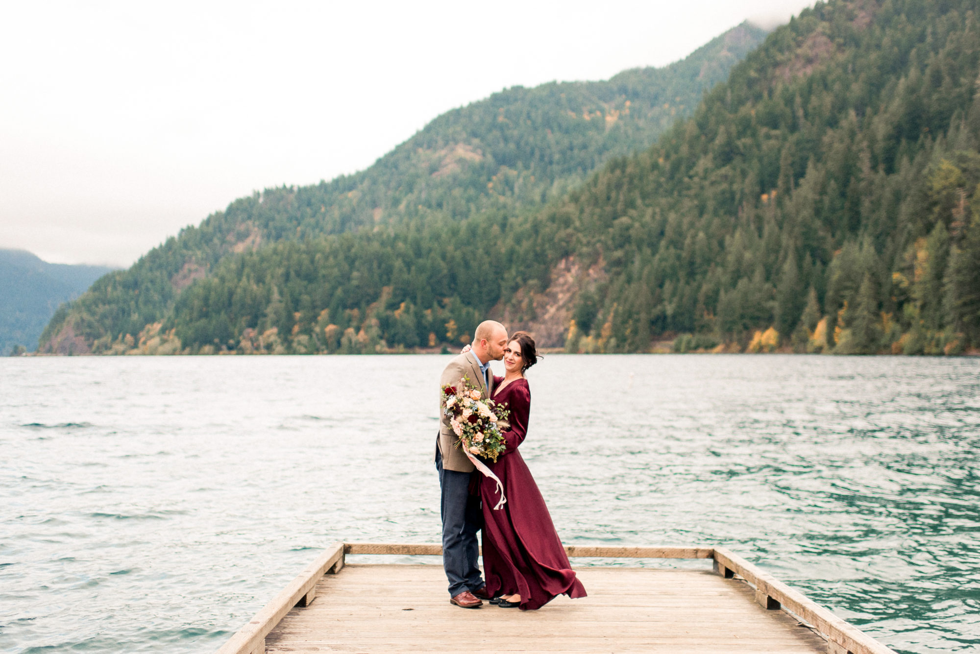 Couple on dock at Lake crescent with bouquet