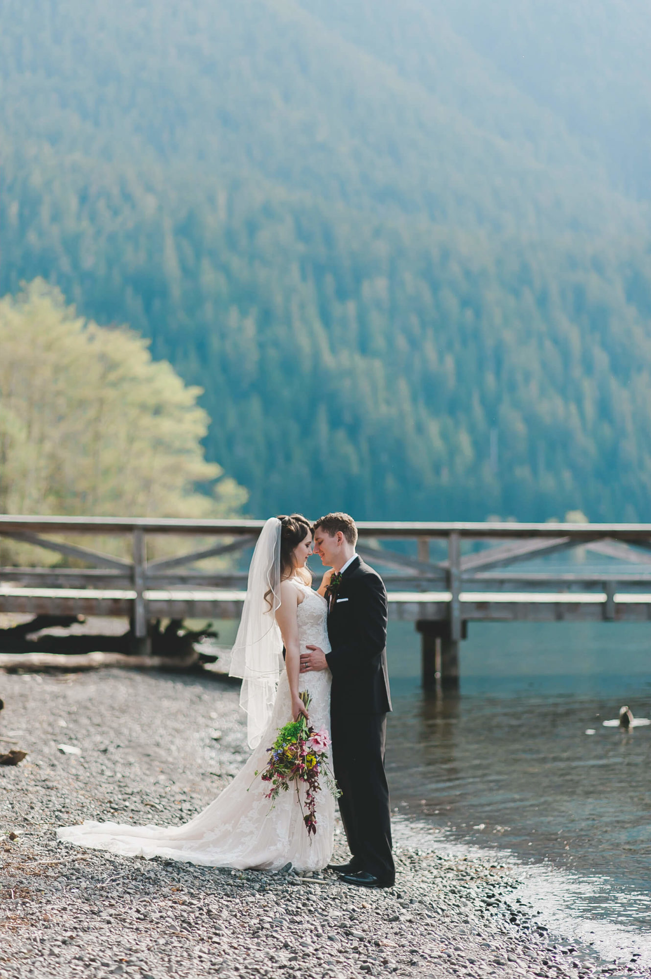 Bride and groom on the beach at Lake Crescent