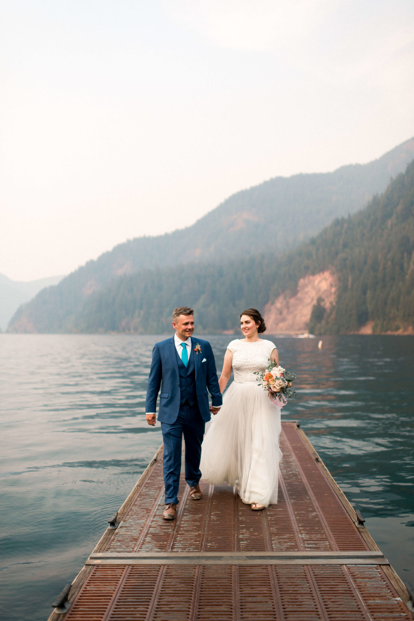 Bride and Groom on a dock at Lake Crescent elopement