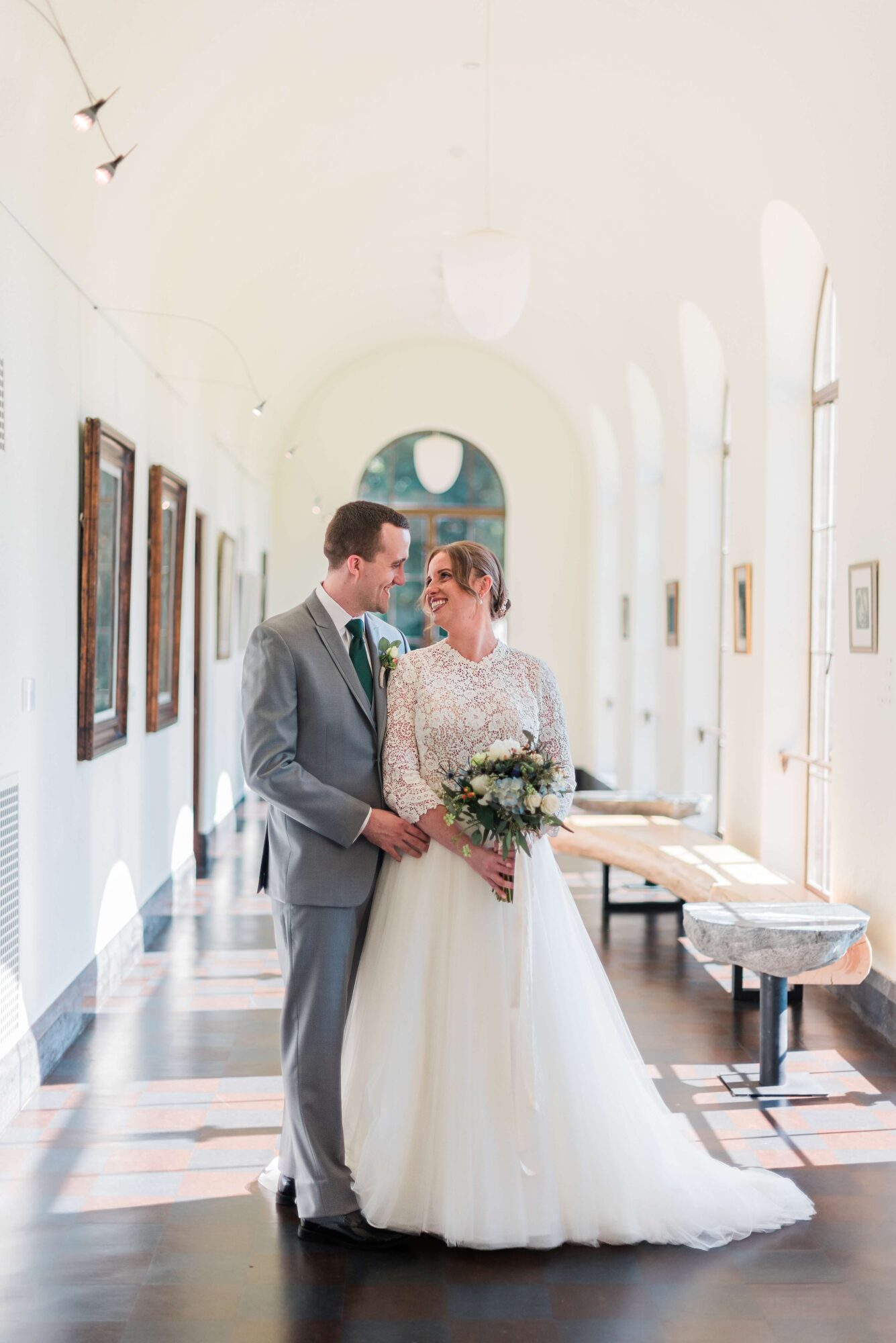 Bride and Groom portraits in the sun-filled art gallery at the Lodge at St. Edward Park wedding