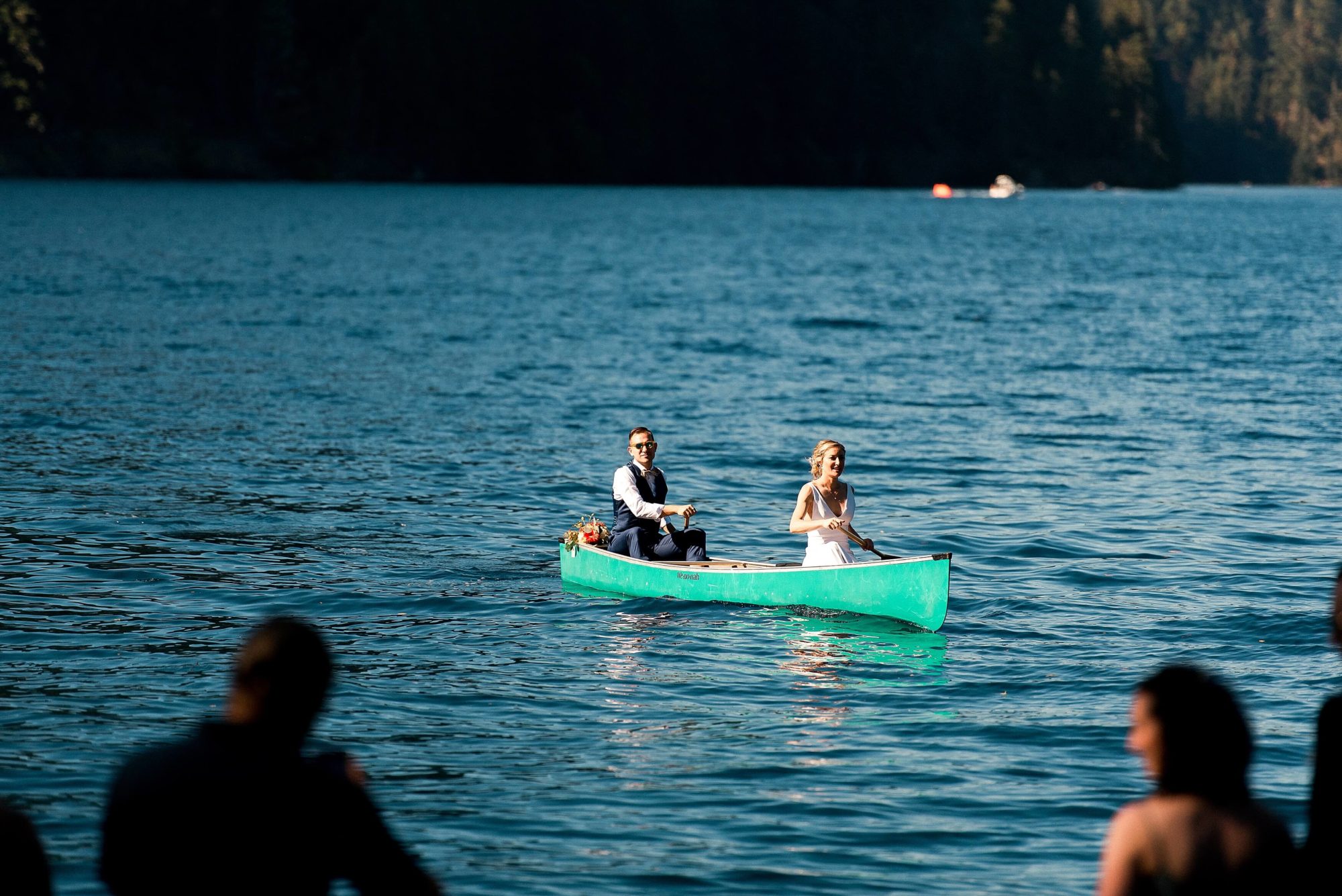 Bride and groom paddling canoe at NatureBridge Wedding venue