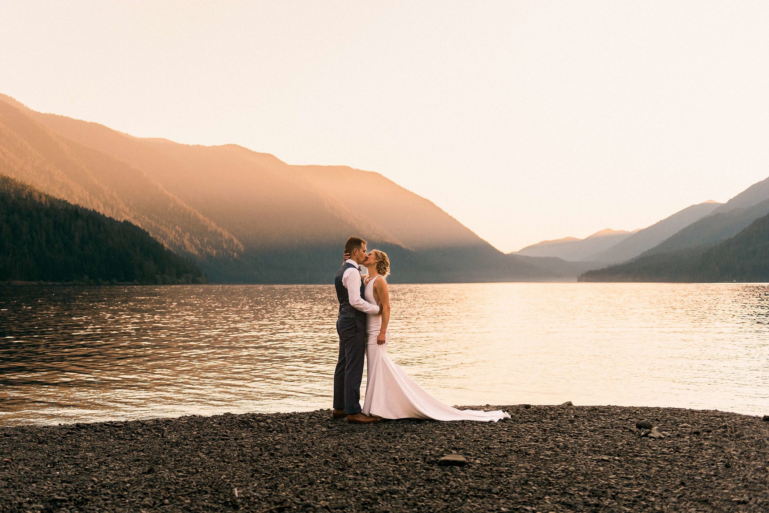 couple kissing on waterfront at Naturebridge wedding venue