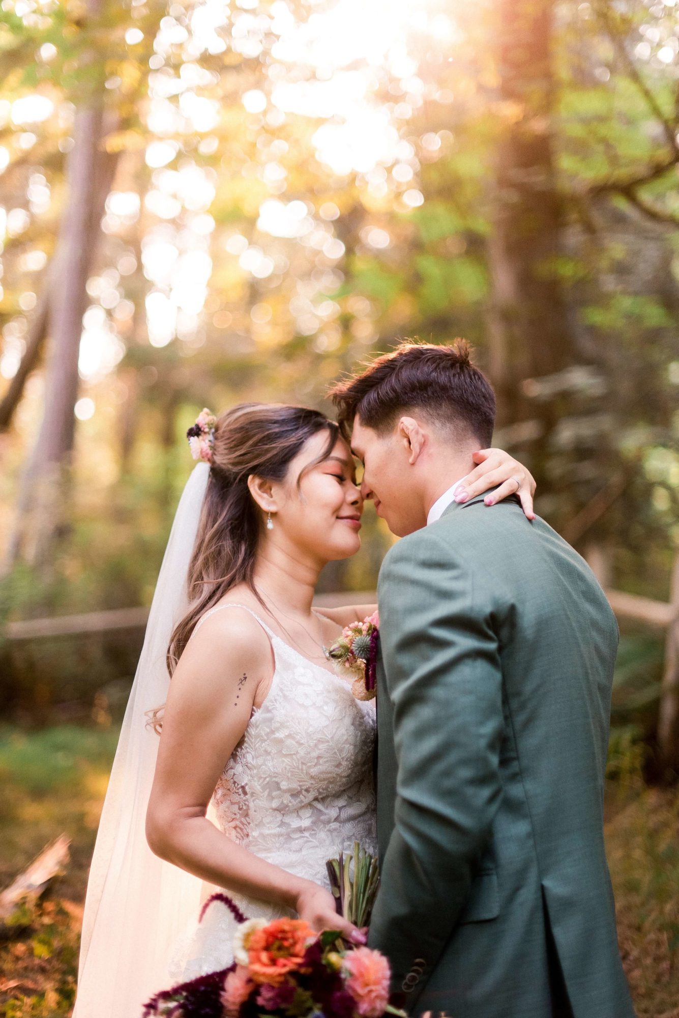 bride and groom embrace in the forest at The Lodge at St. Edwards wedding venue