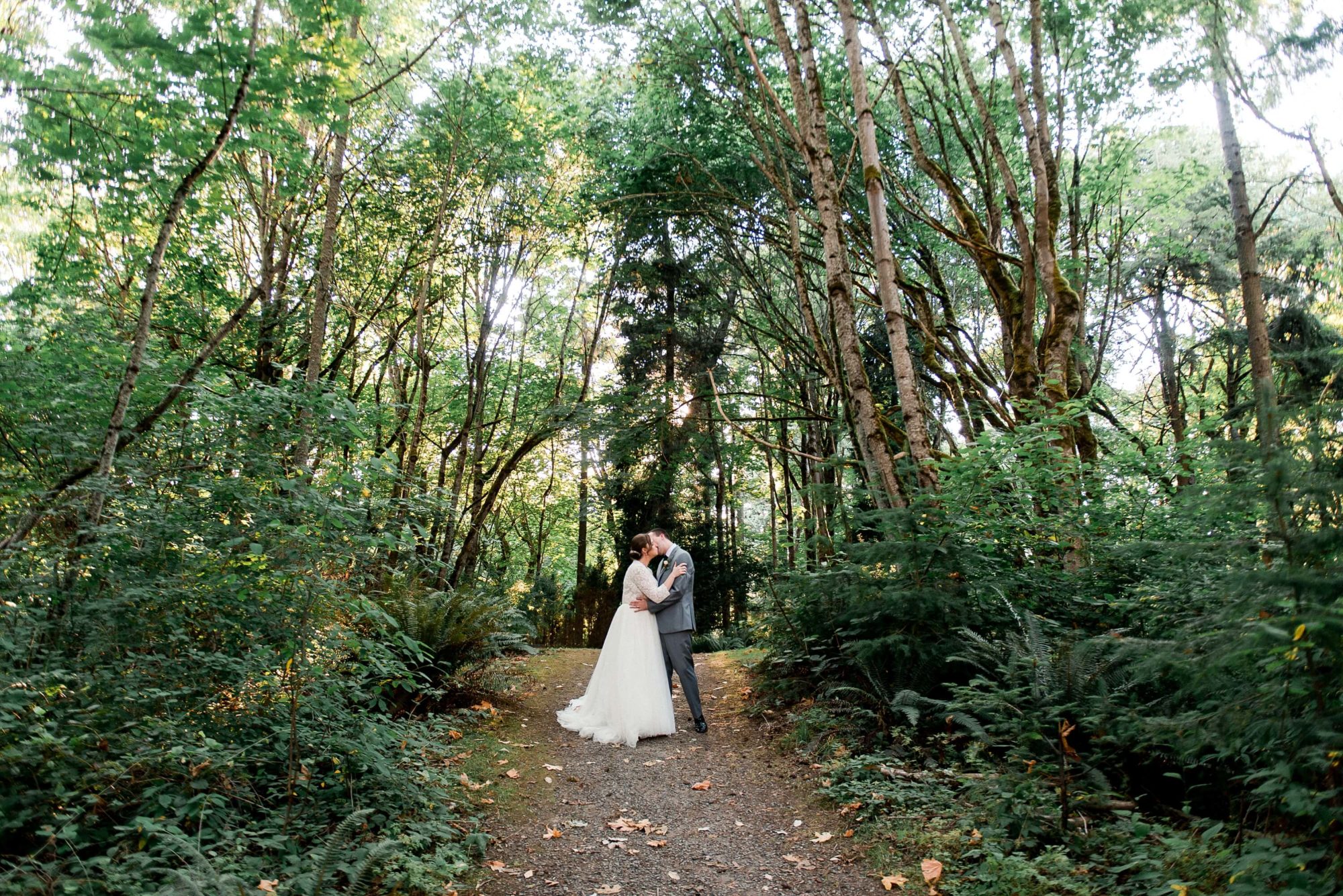 bride and groom embracing in the forest at Islandwood wedding venue