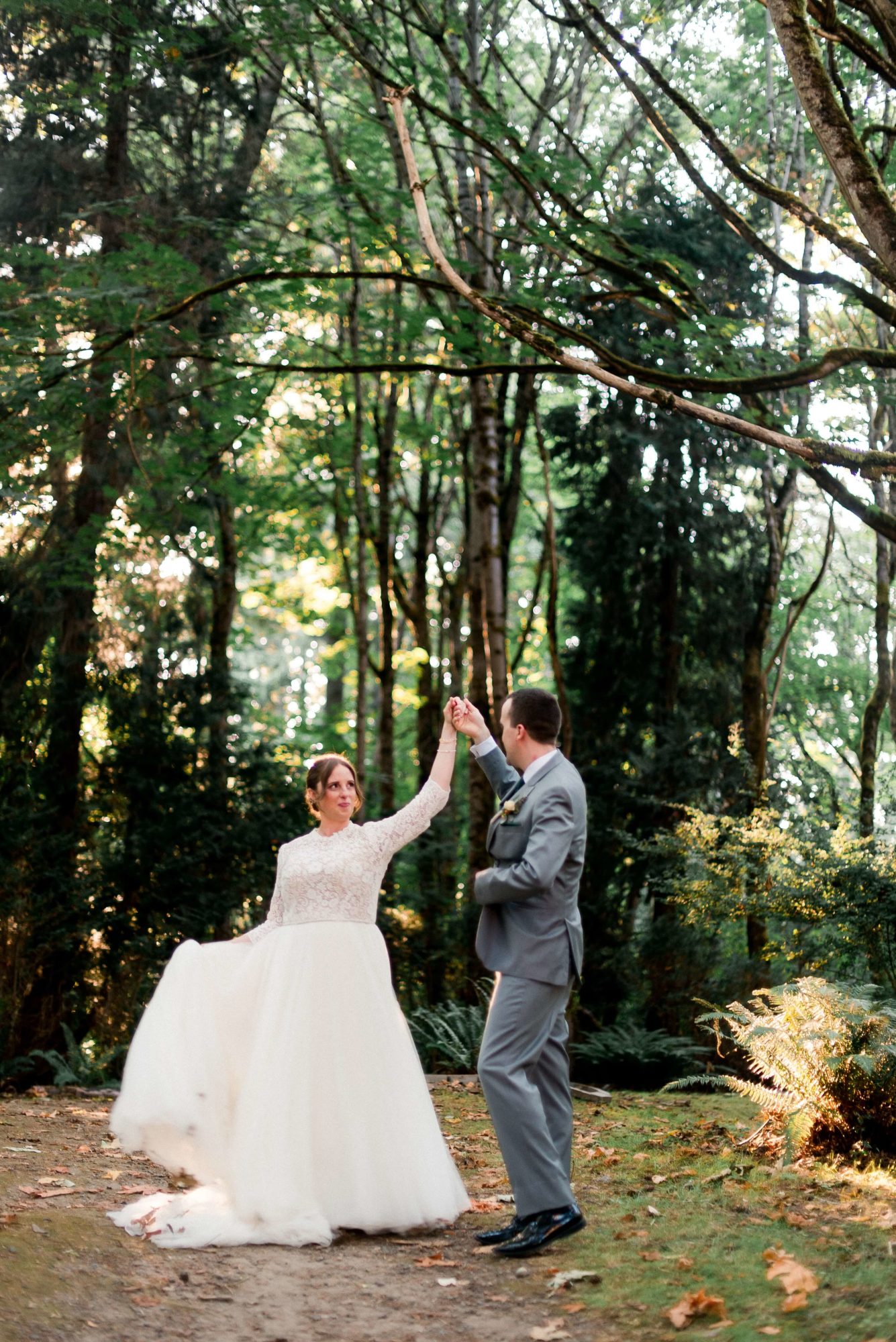 bride and groom dancing in the forest at Islandwood wedding venue