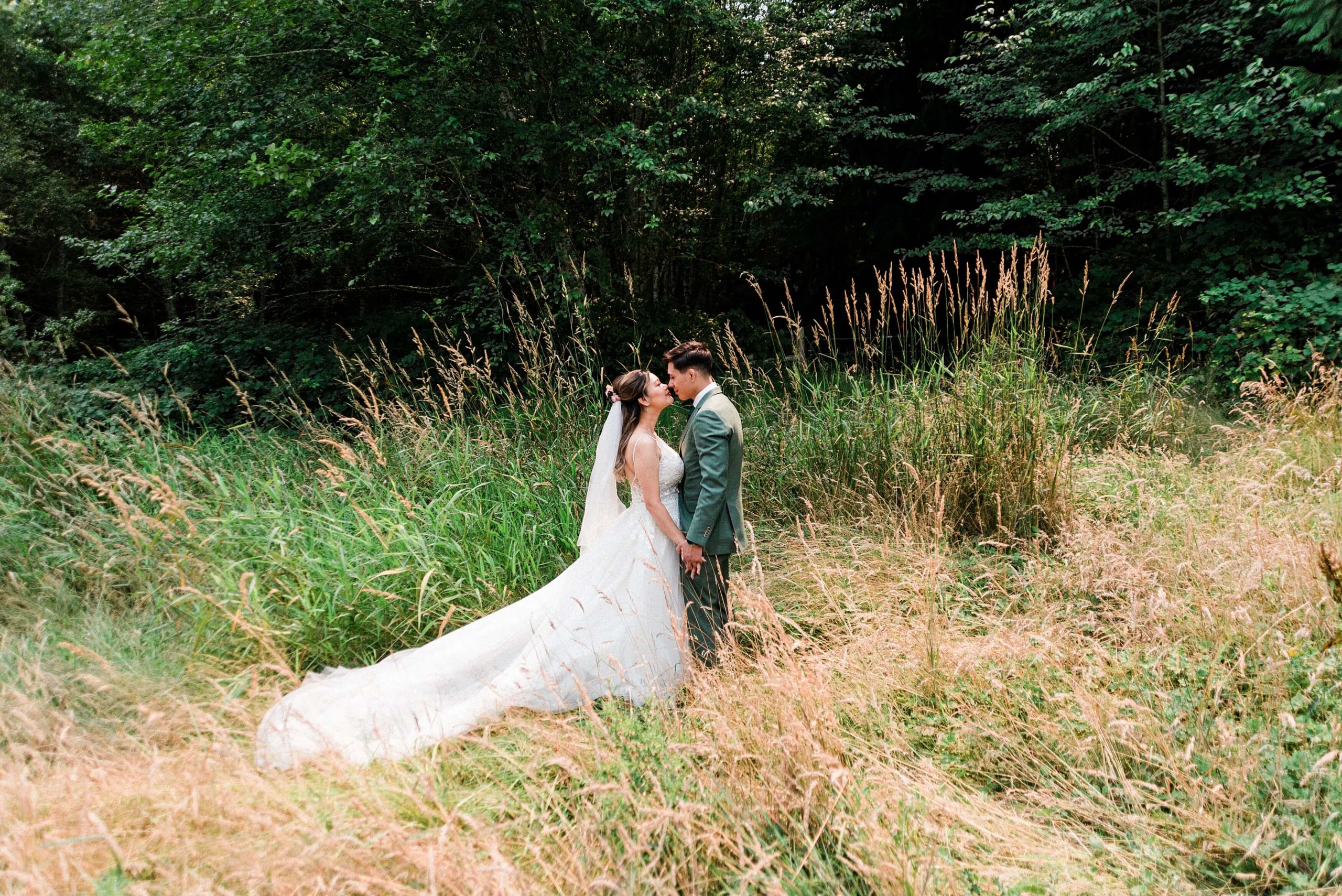 Bride and groom in a meadow at Misty Clover Farm Olympic Peninsula Wedding Venue
