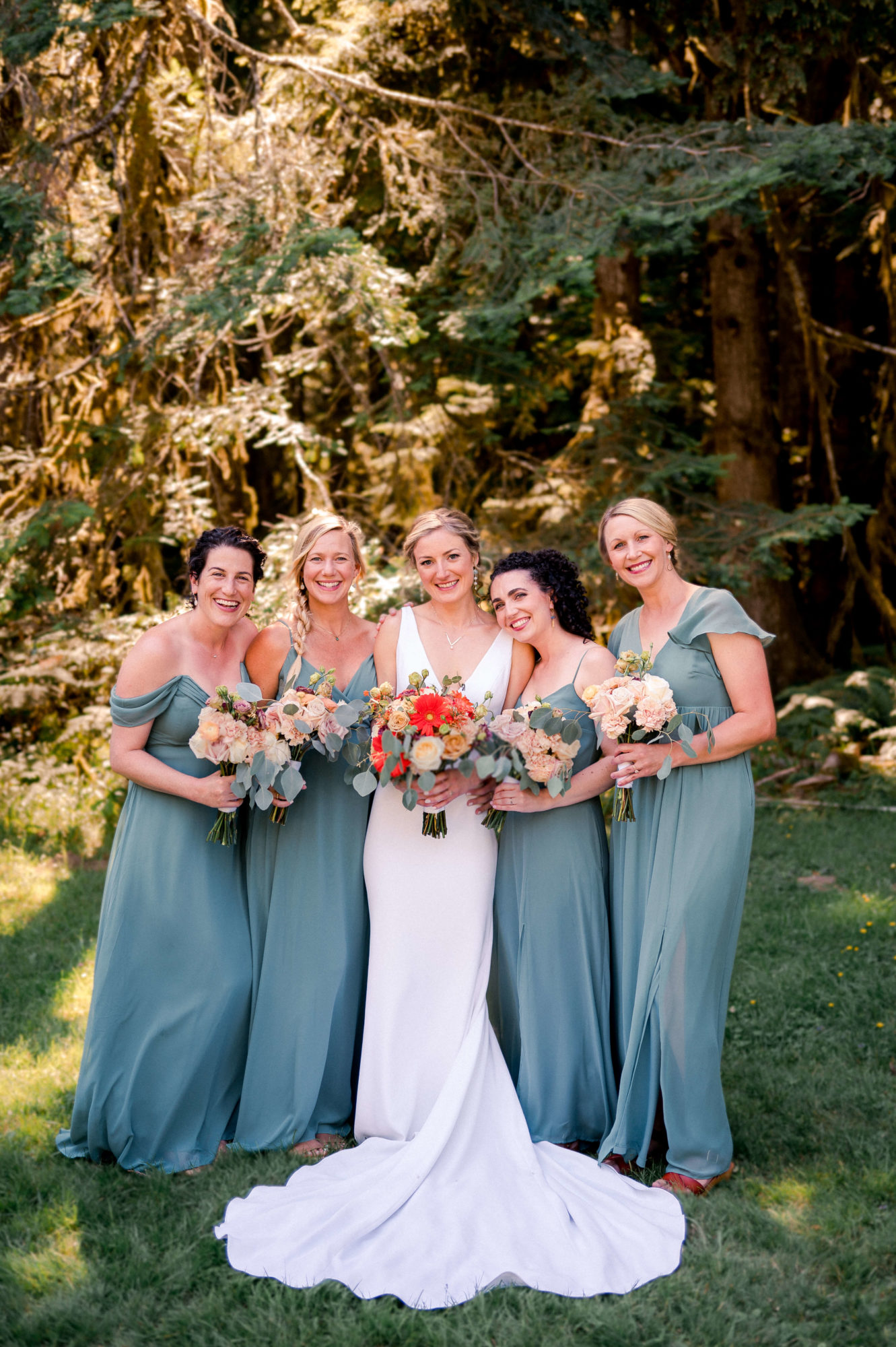 Bride and bridesmaids in a forest on vashon Island