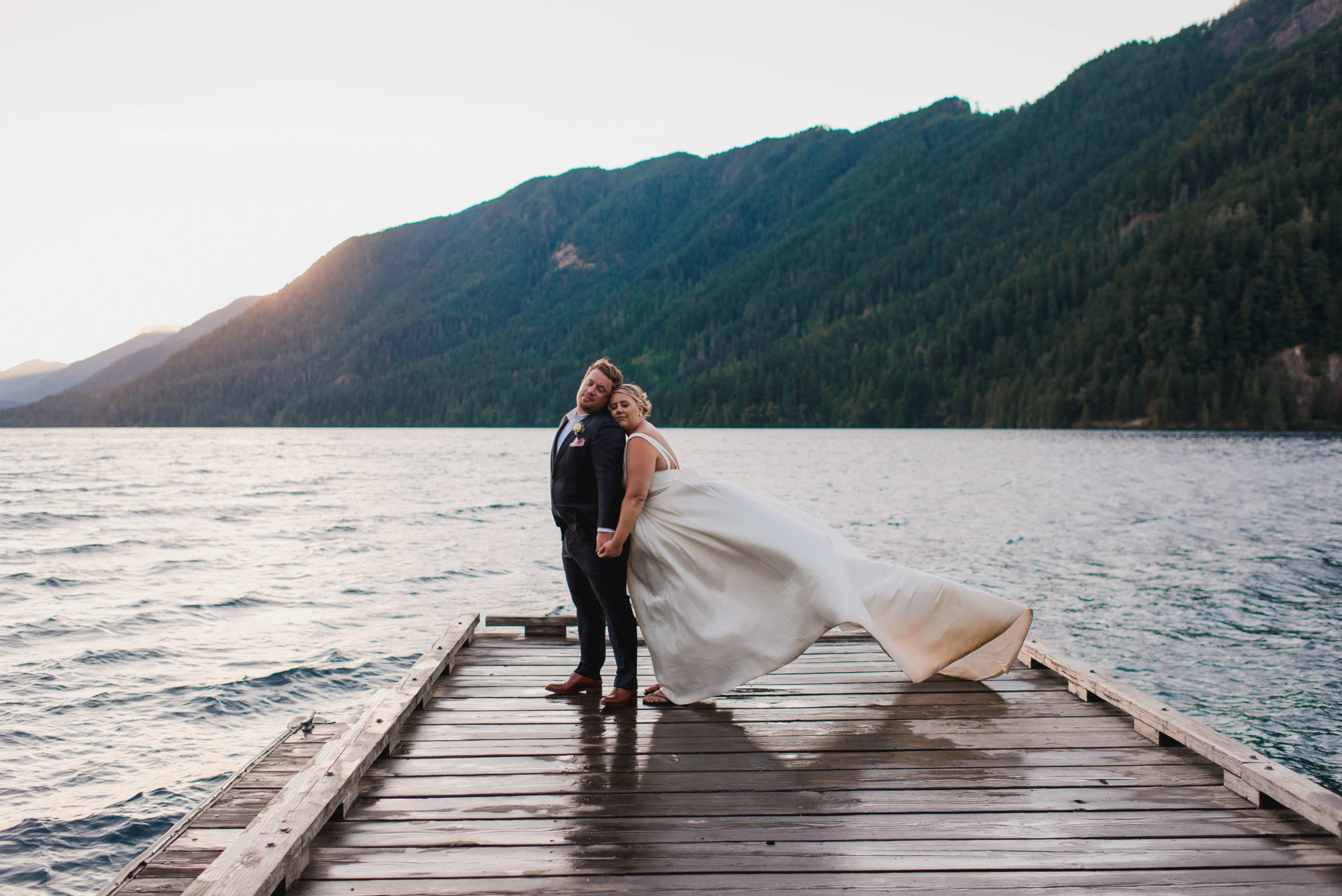 Bride and groom on the dock at sunset at Lake Crescent in Olympic National Park