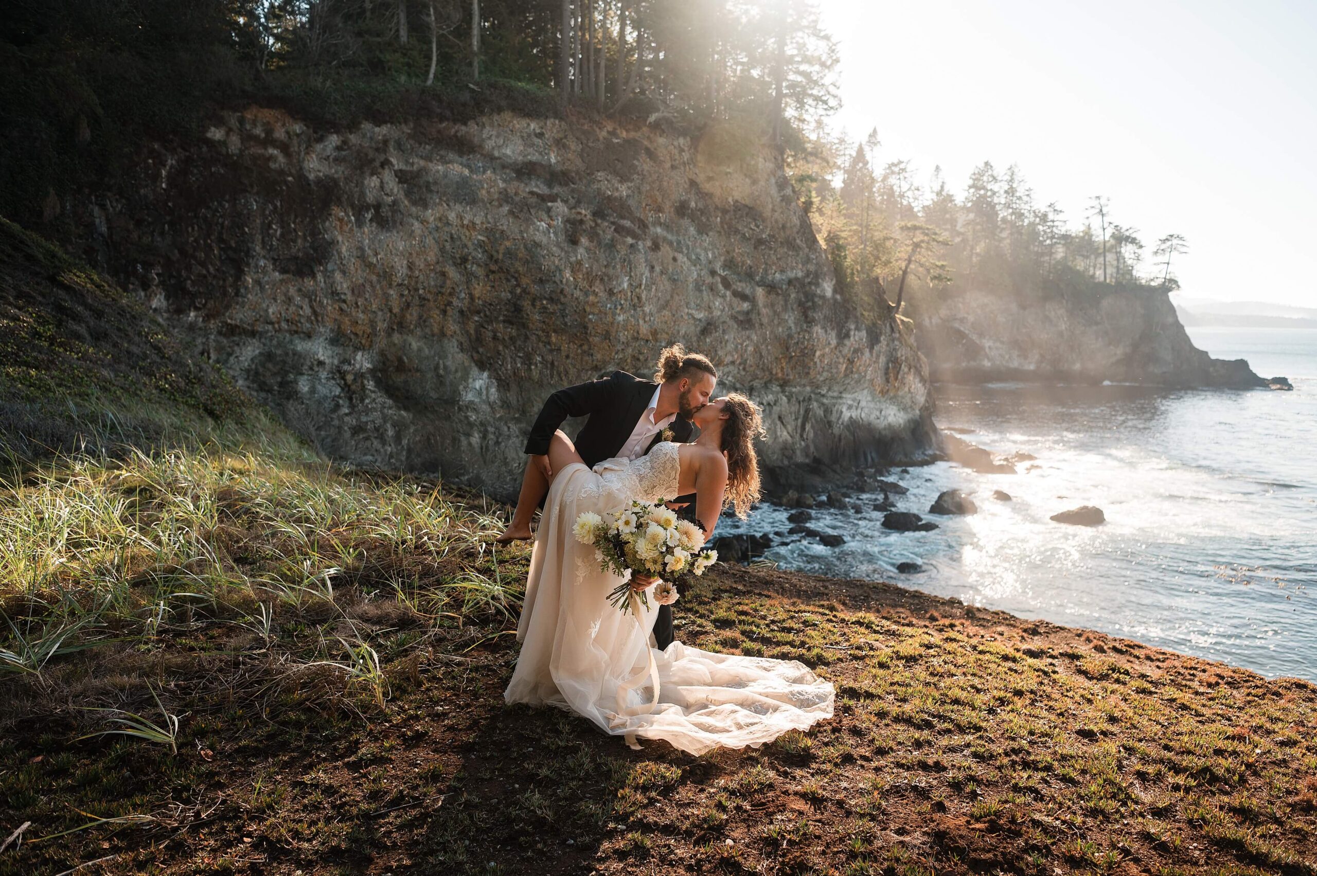 Bride and groom eloping at sunset on a cliff on the Washington Coast