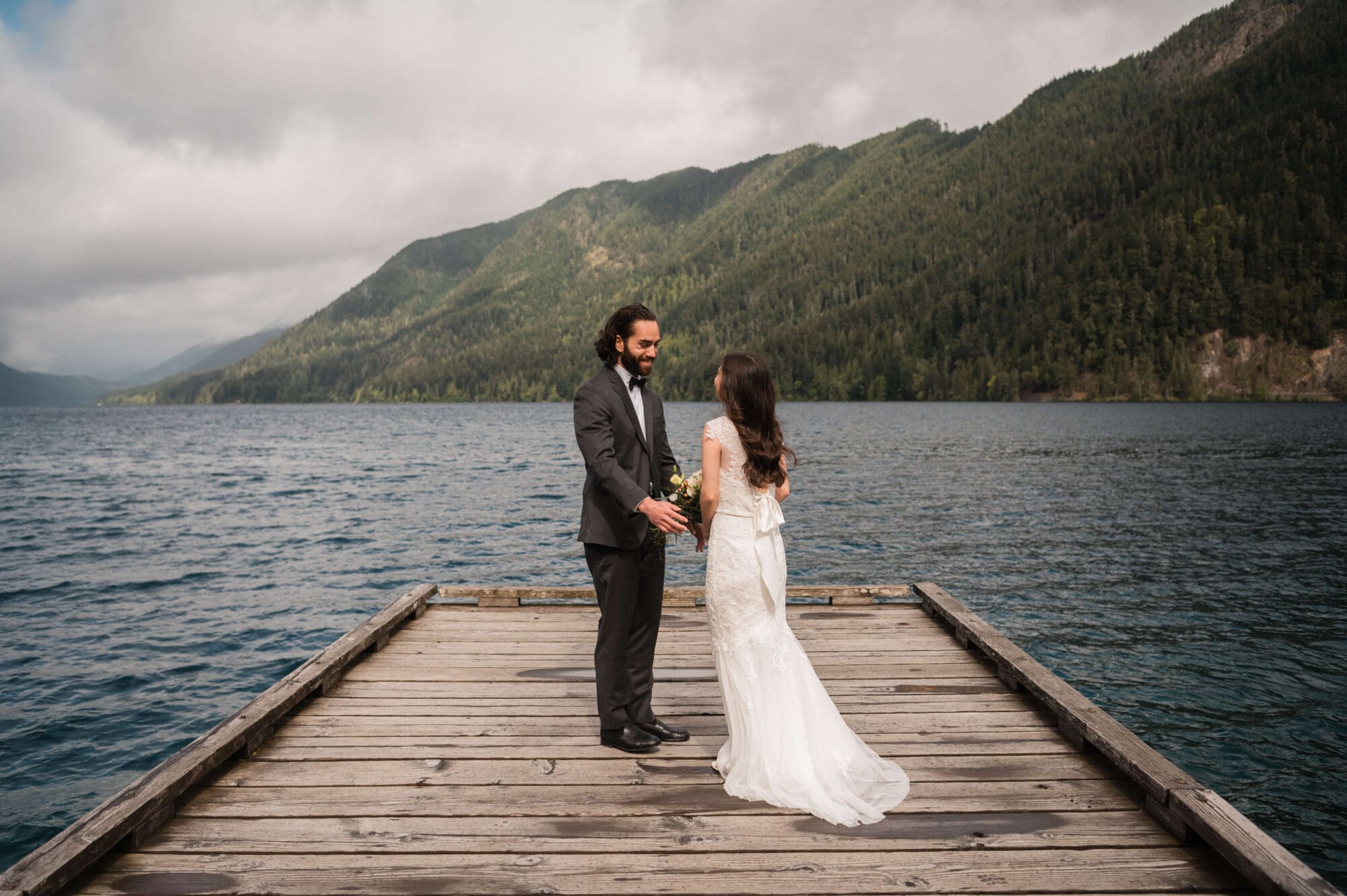 Bride and groom First look on the dock at Lake Crescent Lodge in Olympic National Park